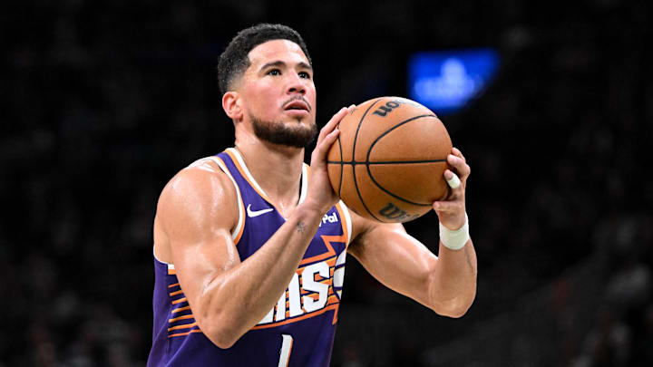 Mar 16, 2026; Boston, Massachusetts, USA; Phoenix Suns guard Devin Booker (1) attempts a free throw against the Boston Celtics during the first half at the TD Garden. Mandatory Credit: Brian Fluharty-Imagn Images