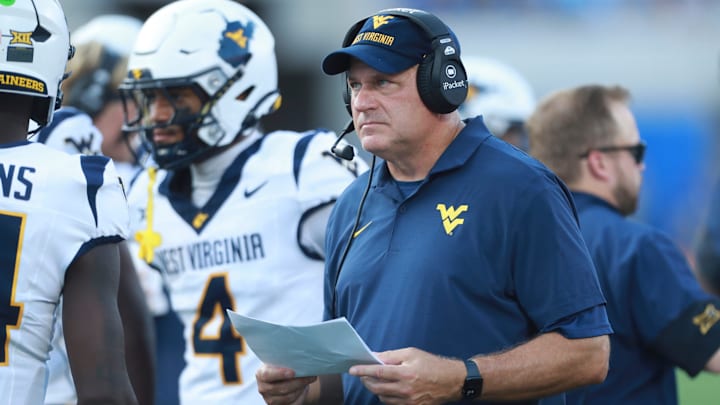 West Virginia Mountaineers head coach Rich Rodriguez looks at plays during the first half of the game against Kansas Jayhawks at David Booth Kansas Memorial Stadium on Sept. 20, 2025.