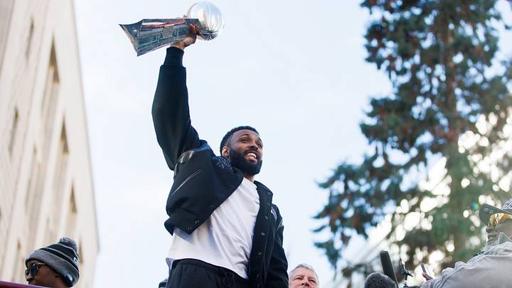 Seattle Seahawks safety Julian Love (20) celebrates with the Vince Lombardi trophy during the Super Bowl LX parade. Seattle Seahawks safety Julian Love (20) celebrates with the Vince Lombardi trophy during the Super Bowl LX parade.