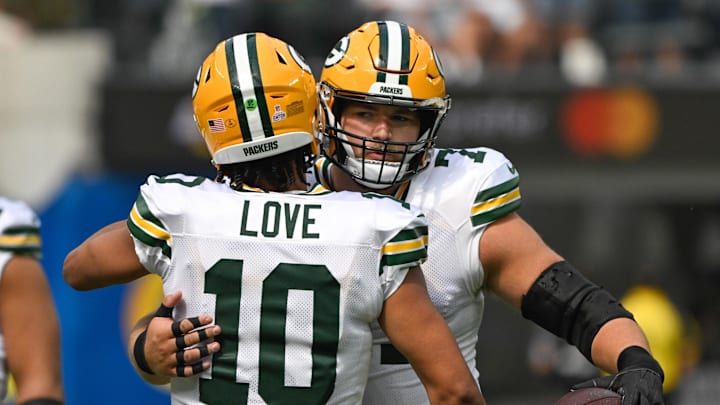Oct 6, 2024; Inglewood, California, USA; Green Bay Packers quarterback Jordan Love (10) hugs center Josh Myers (71) before an NFL game against the Los Angeles Rams at SoFi Stadium. Mandatory Credit: Robert Hanashiro-Imagn Images