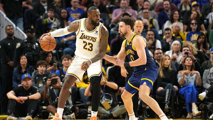 Jan 27, 2024; San Francisco, California, USA; Los Angeles Lakers forward LeBron James (23) dribbles against Golden State Warriors guard Klay Thompson (right) during the fourth quarter at Chase Center. Mandatory Credit: Darren Yamashita-USA TODAY Sports