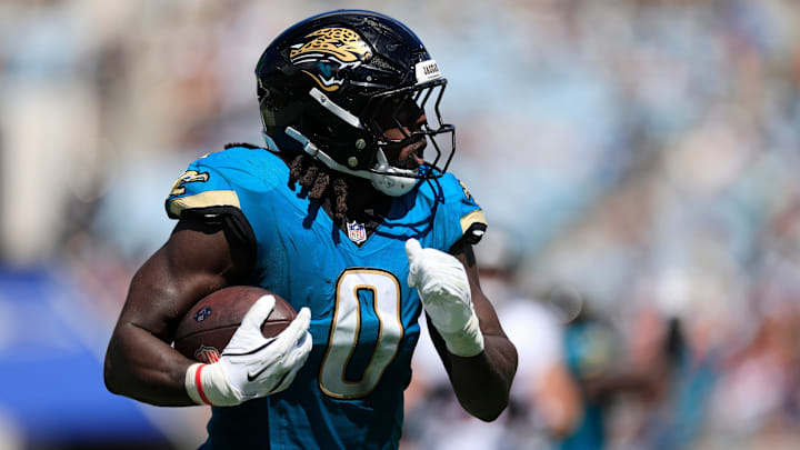 Jacksonville Jaguars linebacker Devin Lloyd (0) rushes for yards during the second quarter of an NFL football matchup