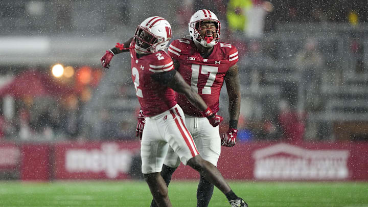 Nov 8, 2025; Madison, Wisconsin, USA;  Wisconsin Badgers linebacker Darryl Peterson III (17) and cornerback Ricardo Hallman (2) celebrate following a play during the fourth quarter against the Washington Huskies at Camp Randall Stadium. Mandatory Credit: Jeff Hanisch-Imagn Images