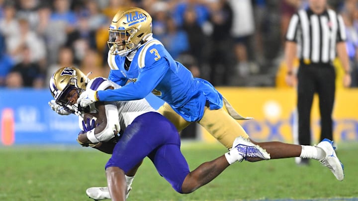 Sep 30, 2022; Pasadena, California, USA; Washington Huskies wide receiver Giles Jackson (0) is stopped by UCLA Bruins defensive back Devin Kirkwood (3) after a complete pass in the second half at the Rose Bowl. Mandatory Credit: Jayne Kamin-Oncea-Imagn Images Sep 30, 2022; Pasadena, California, USA; Washington Huskies wide receiver Giles Jackson (0) is stopped by UCLA Bruins defensive back Devin Kirkwood (3) after a complete pass in the second half at the Rose Bowl. Mandatory Credit: Jayne Kamin-Oncea-Imagn Images