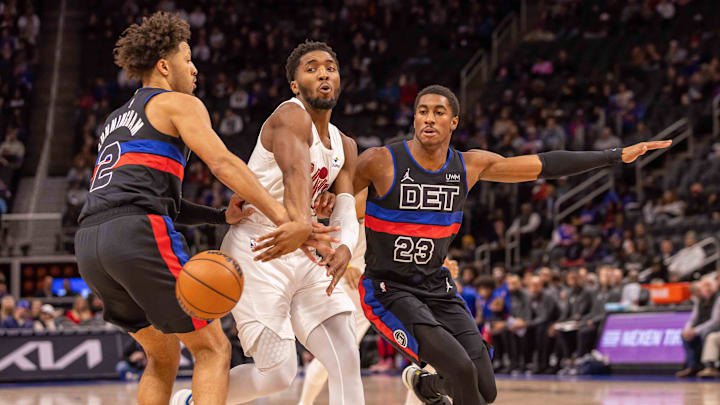 Dec 2, 2023; Detroit, Michigan, USA; Cleveland Cavaliers guard Donovan Mitchell (45) drives the ball against Cade Cunningham and Jaden Ivey of the Detroit Pistons