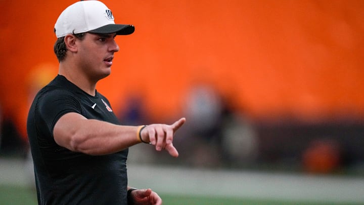 Cincinnati Bengals defensive end Trey Hendrickson assists with drills during a preseason training camp practice. Cincinnati Bengals defensive end Trey Hendrickson assists with drills during a preseason training camp practice.