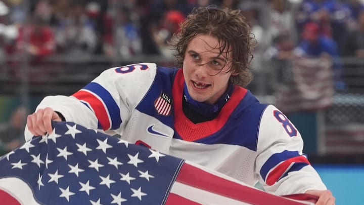 Feb 22, 2026; Milan, Italy; Jack Hughes (86) of the United States celebrates after defeating Canada in the men's ice hockey gold medal game during the Milano Cortina 2026 Olympic Winter Games at Milano Santagiulia Ice Hockey Arena. Mandatory Credit: Amber Searls-Imagn Images