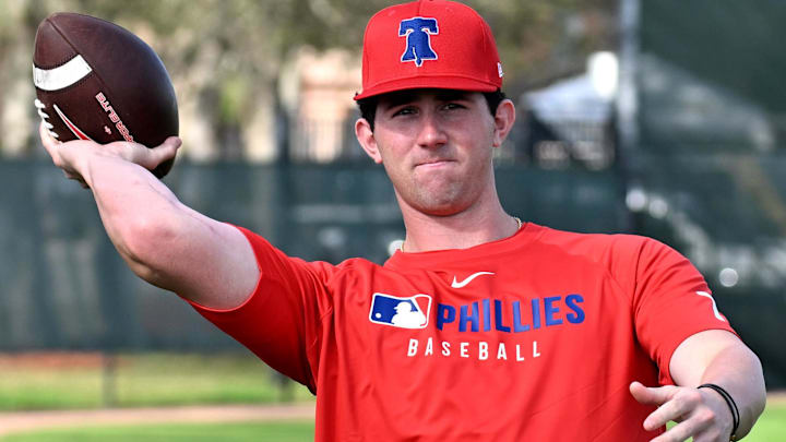 Feb 12, 2025; Clearwater, FL, USA; Philadelphia Phillies pitcher Andrew Painter (76) throws a football during a spring training workout at Carpenter Complex in Clearwater, Fla., on Feb. 12, 2025.
