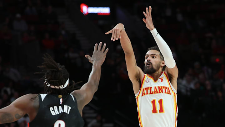 Nov 17, 2024; Portland, Oregon, USA: Atlanta Hawks guard Trae Young (11) shoots the ball over Portland Trail Blazers forward Jerami Grant (9)  in the second half at Moda Center. Mandatory Credit: Jaime Valdez-Imagn Images