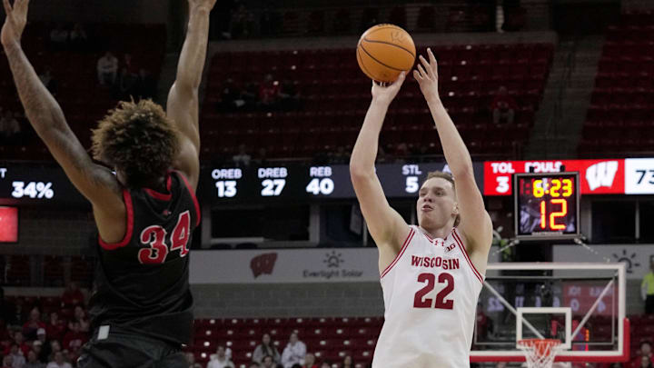 Wisconsin forward Austin Rapp (22) attempts a three-point shot over Ball State forward Preston Copeland (34) during the second half of their game Tuesday, November 11, 2025 at the Kohl Center in Madison, Wisconsin. Wisconsin beat Ball State 86-55.