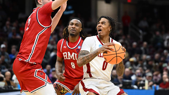 Mar 21, 2025; Cleveland, OH, USA; Alabama Crimson Tide guard Labaron Philon (0) controls the ball defende day Robert Morris Colonials forward Alvaro Folgueiras (7) in the first half during the NCAA Tournament First Round at Rocket Arena. Mandatory Credit: Ken Blaze-Imagn Images