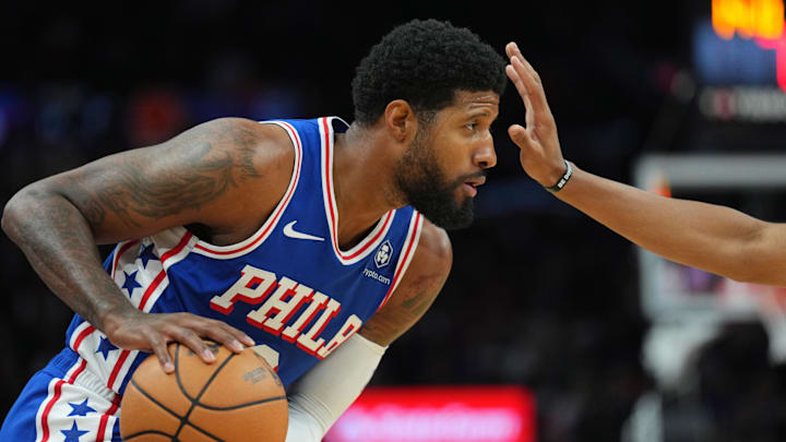 Philadelphia 76ers forward Paul George (8) protects the ball against the Phoenix Suns during the first half at Footprint Center. Mandatory Credit: Joe Camporeale-Imagn Images
