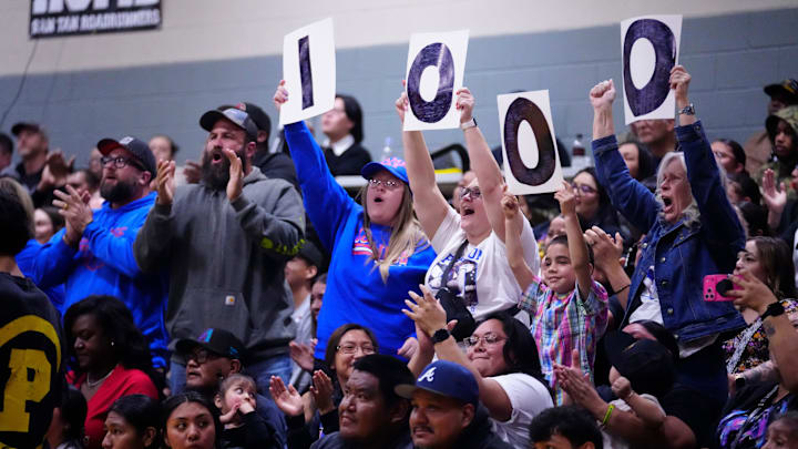 Fans celebrate a Coolidge boys basketball player reaching 1,000 career points in a game against San Tan Charter on Feb. 13. The Bears have been removed from the state playoffs after the AIA placed a one-year postseason ban on Coolidge high school athletics.