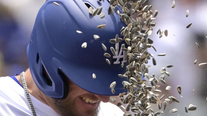 Apr 30, 2025; Los Angeles, California, USA;  Los Angeles Dodgers third baseman Max Muncy (13) gets a sunflower seed shower after hitting a solo home run in the first inning against the Miami Marlins at Dodger Stadium. Mandatory Credit: Jayne Kamin-Oncea-Imagn Images