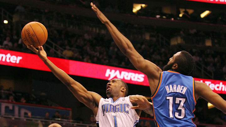 February 25, 2011; Orlando FL, USA; Orlando Magic point guard Gilbert Arenas (1) shoots as Oklahoma City Thunder guard James Harden (13) defends during the second quarter at Amway Center. The Magic won 111-88. 