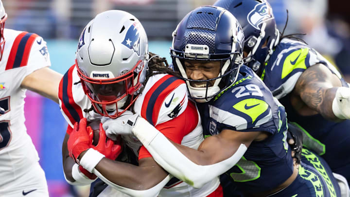 Feb 8, 2026; Santa Clara, CA, USA; Seattle Seahawks cornerback Josh Jobe (29) tackles New England Patriots running back Rhamondre Stevenson (38) during the second quarter in Super Bowl LX at Levi's Stadium. Mandatory Credit: Mark J. Rebilas-Imagn Images
