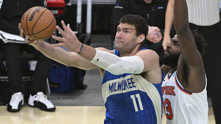 Dec 5, 2023; Milwaukee, Wisconsin, USA: Milwaukee Bucks center Brook Lopez (11) drives to the basket against New York Knicks center Mitchell Robinson (23) in the second half at Fiserv Forum. Mandatory Credit: Michael McLoone-Imagn Images