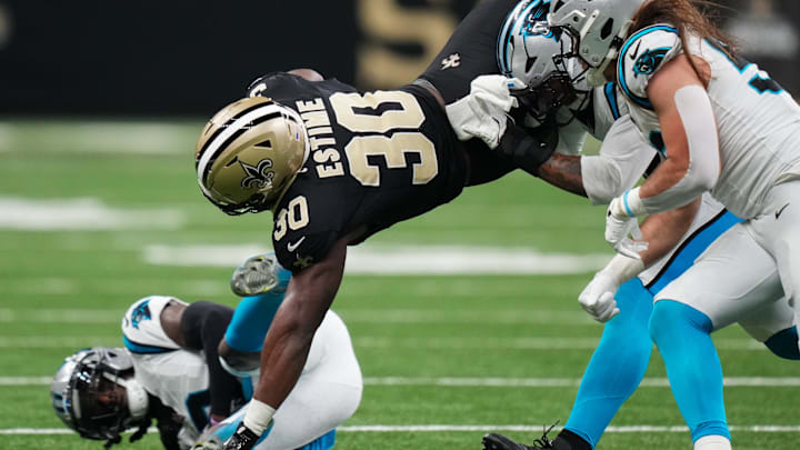 Dec 14, 2025; New Orleans, Louisiana, USA; New Orleans Saints running back Audric Estime (30) is tackled by Carolina Panthers linebacker Trevin Wallace (32) and linebacker Christian Rozeboom (56) during the second quarter at Caesars Superdome. Mandatory Credit: Matthew Hinton-Imagn Images