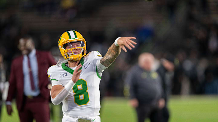 Oct 18, 2024; West Lafayette, Indiana, USA; Oregon Ducks quarterback Dillon Gabriel (8) throws a pass to warm up before the game against the Purdue Boilermakers at Ross-Ade Stadium. Mandatory Credit: Marc Lebryk-Imagn Images