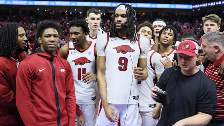 Mar 8, 2025; Fayetteville, Arkansas, USA; Arkansas Razorbacks forward Jonas Aidoo (9), flanked by teammates  is interviewed after the game against the Mississippi State Bulldogs at Bud Walton Arena. Arkansas won 93-92. Mandatory Credit: Nelson Chenault-Imagn Images