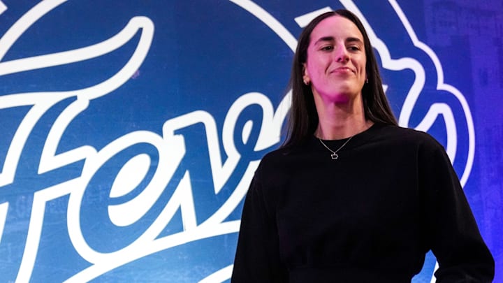 Indiana Fever guard Caitlin Clark (22) walks past the photo backdrop Wednesday, Aug. 28, 2024, during a game between the Indiana Fever and the Connecticut Sun at Gainbridge Fieldhouse in Indianapolis. Indiana Fever guard Caitlin Clark (22) walks past the photo backdrop Wednesday, Aug. 28, 2024, during a game between the Indiana Fever and the Connecticut Sun at Gainbridge Fieldhouse in Indianapolis.