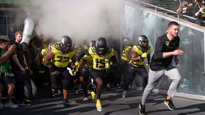 Oregon coach Dan Lanning lead his team onto the field veer their game against Illinois at Autzen Stadium in Eugene Saturday, Oct 26, 2024.