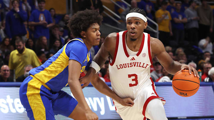 Jan 17, 2026; Pittsburgh, Pennsylvania, USA; Louisville Cardinals guard Ryan Conwell (3) drives to the basket against Pittsburgh Panthers guard Brandin Cummings (left) during the first half at the Petersen Events Center. Mandatory Credit: Charles LeClaire-Imagn Images