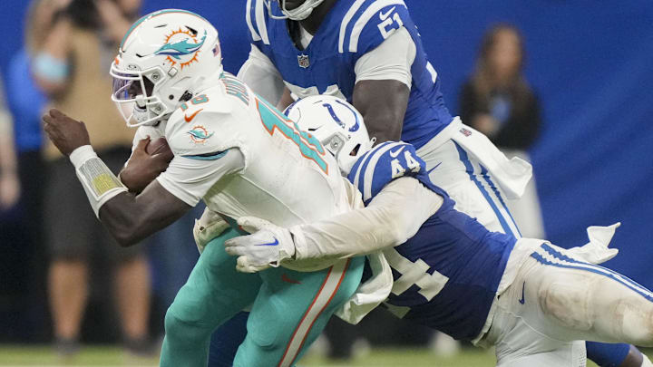 Indianapolis Colts linebacker Zaire Franklin (44) tackles Miami Dolphins quarterback Tyler Huntley (18) during a game against the Miami Dolphins at Lucas Oil Stadium.
