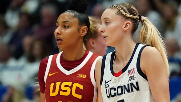 Dec 21, 2024; Hartford, Connecticut, USA; UConn Huskies guard Paige Bueckers (5) and USC Trojans guard JuJu Watkins (12) on the court in the first half at XL Center. Mandatory Credit: David Butler II-Imagn Images Dec 21, 2024; Hartford, Connecticut, USA; UConn Huskies guard Paige Bueckers (5) and USC Trojans guard JuJu Watkins (12) on the court in the first half at XL Center. Mandatory Credit: David Butler II-Imagn Images