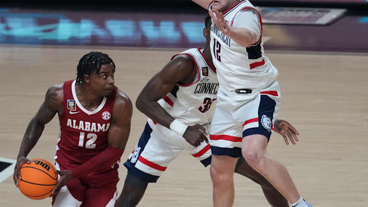 Apr 6, 2024; Glendale, AZ, USA;  Alabama Crimson Tide guard Latrell Wrightsell Jr. (12) is defended by Connecticut Huskies guard Cam Spencer (12) in the semifinals of the men's Final Four of the 2024 NCAA Tournament at State Farm Stadium. Mandatory Credit: Joe Rondone/Arizona Republic-USA TODAY Sports