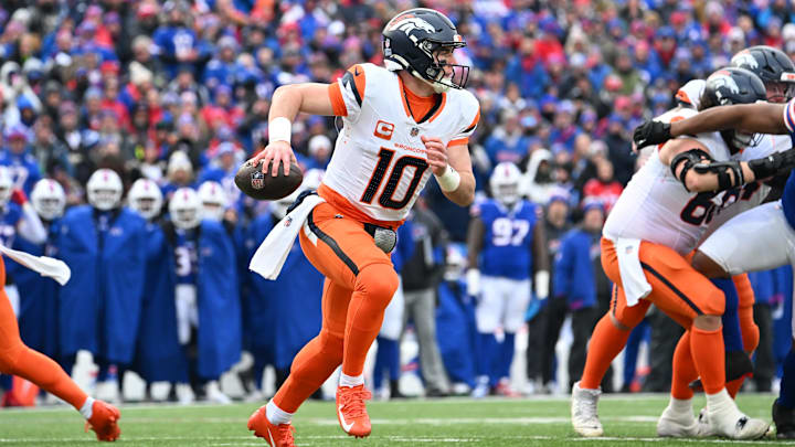 Jan 12, 2025; Orchard Park, New York, USA; Denver Broncos quarterback Bo Nix (10) runs for a gain during the second quarter against the Buffalo Bills in an AFC wild card game at Highmark Stadium. Mandatory Credit: Mark Konezny-Imagn Images