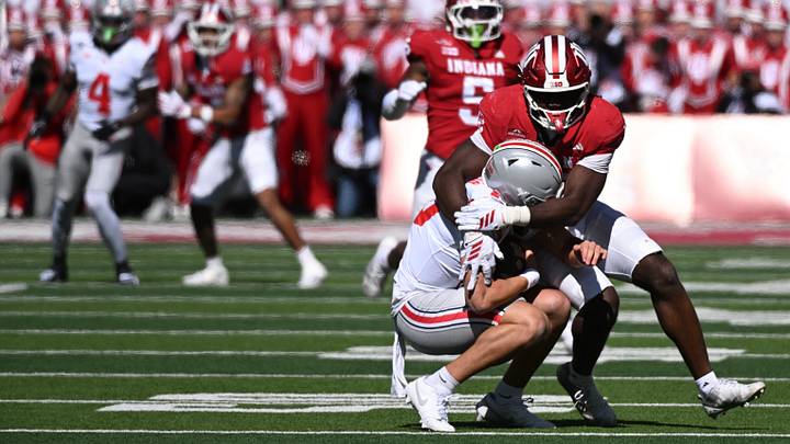 Oct 17, 2026; Bloomington, Indiana, USA; Indiana Hoosiers defensive line Tobi Osunsanmi (12) sacks Ohio State Buckeyes quarterback Julian Sayin (10) during the first half at Merchants Bank Field at Memorial Stadium. Mandatory Credit: Robert Goddin-Imagn Images Oct 17, 2026; Bloomington, Indiana, USA; Indiana Hoosiers defensive line Tobi Osunsanmi (12) sacks Ohio State Buckeyes quarterback Julian Sayin (10) during the first half at Merchants Bank Field at Memorial Stadium. Mandatory Credit: Robert Goddin-Imagn Images