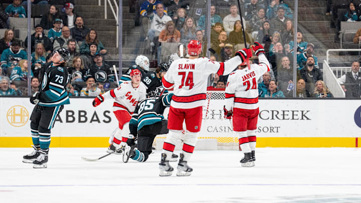 Mar 20, 2025; San Jose, California, USA; Carolina Hurricanes center Seth Jarvis (24) and Carolina Hurricanes defenseman Jaccob Slavin (74) and teammates celebrate after the goal against the San Jose Sharks during the second period at SAP Center at San Jose. Mandatory Credit: Neville E. Guard-Imagn Images