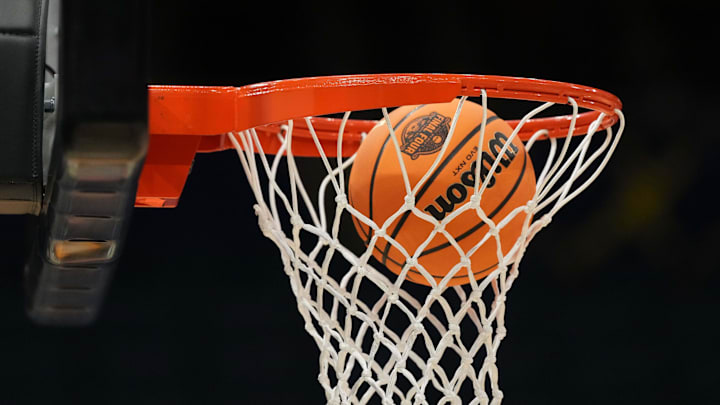 Apr 3, 2025; Tampa, FL, USA; A Wilson EVO Nxt basketball ball with the 2025 NCAA logo approaches the rim and the net at Amalie Arena. 