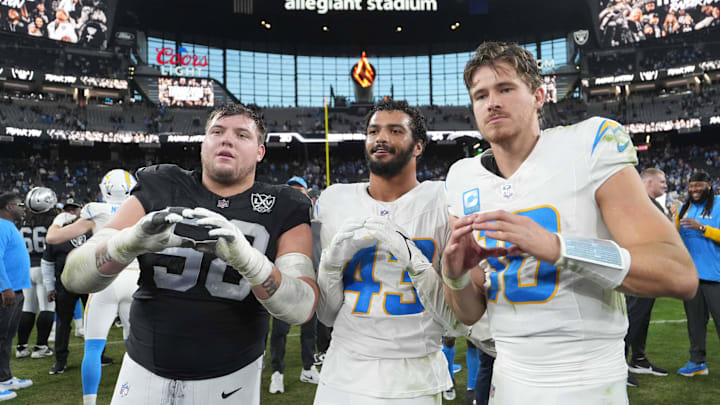 Jan 5, 2025; Paradise, Nevada, USA; Oregon Ducks former players (from left) Las Vegas Raiders guard Jackson Powers-Johnson (58) and Los Angeles Chargers linebacker Troy Dye (43) and quarterback Justin Herbert (10) pose after the game at Allegiant Stadium. Mandatory Credit: Kirby Lee-Imagn Images
