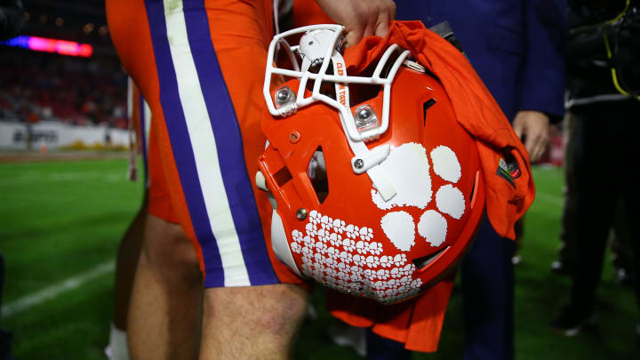 Dec 28, 2019; Glendale, AZ, USA; Detailed view of the football helmet in the hand of Clemson Tigers quarterback Trevor Lawrence (16) following the game against the Ohio State Buckeyes in the 2019 Fiesta Bowl college football playoff semifinal game at State Farm Stadium Dec 28, 2019; Glendale, AZ, USA; Detailed view of the football helmet in the hand of Clemson Tigers quarterback Trevor Lawrence (16) following the game against the Ohio State Buckeyes in the 2019 Fiesta Bowl college football playoff semifinal game at State Farm Stadium