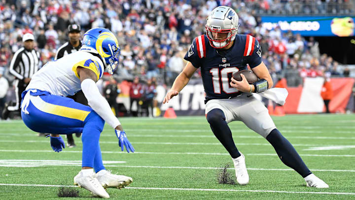 Nov 17, 2024; Foxborough, Massachusetts, USA; New England Patriots quarterback Drake Maye (10) prepares to take a hit from Los Angeles Rams safety Kamren Curl (3) during the second half at Gillette Stadium. Mandatory Credit: Eric Canha-Imagn Images