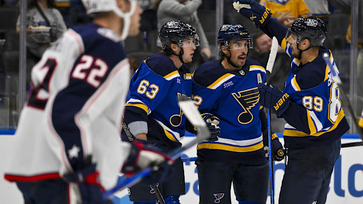 Oct 1, 2024; St. Louis, Missouri, USA;  St. Louis Blues defenseman Justin Faulk (72) is congratulated by left wing Jake Neighbours (63) and left wing Pavel Buchnevich (89) after scoring against the Columbus Blue Jackets during the second period at Enterprise Center. Mandatory Credit: Jeff Curry-Imagn Images