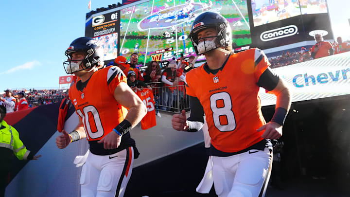 Dec 14, 2025; Denver, Colorado, USA; Denver Broncos quarterback Bo Nix (10) and quarterback Jarrett Stidham (8) run out for player introductions prior to a game against the Green Bay Packers at Empower Field at Mile High. 