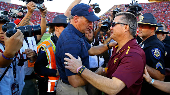 Nov 28, 2014; Tucson, AZ, USA; Arizona Wildcats head coach Rich Rodriguez (left) greets Arizona State Sun Devils head coach Todd Graham following the 88th annual territorial cup at Arizona Stadium. The Wildcats defeated the Sun Devils 42-35 to win the Pac-12 south title. Mandatory Credit: Mark J. Rebilas-Imagn Images Nov 28, 2014; Tucson, AZ, USA; Arizona Wildcats head coach Rich Rodriguez (left) greets Arizona State Sun Devils head coach Todd Graham following the 88th annual territorial cup at Arizona Stadium. The Wildcats defeated the Sun Devils 42-35 to win the Pac-12 south title. Mandatory Credit: Mark J. Rebilas-Imagn Images
