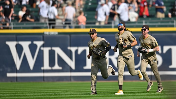 Sep 21, 2025; Chicago, Illinois, USA; San Diego Padres left fielder Ramon Laureano (5), center fielder Jackson Merrill (3), and right fielder Fernando Tatis Jr. (23) celebrate after defeating the Chicago White Sox at Rate Field. 