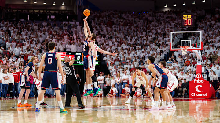 Feb 1, 2026; Lincoln, Nebraska, USA; Illinois Fighting Illini center Tomislav Ivisic (13) and Nebraska Cornhuskers forward Rienk Mast (51) tip off to start the game at Pinnacle Bank Arena. Mandatory Credit: Dylan Widger-Imagn Images