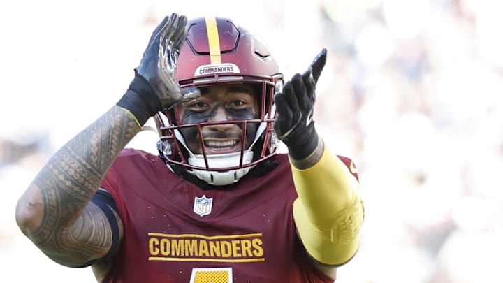 Washington Commanders linebacker Frankie Luvu (4) gestures to fans in the stands after making a tackle against the Dallas Cowboys at Northwest Stadium. Mandatory Credit: Geoff Burke-Imagn Images