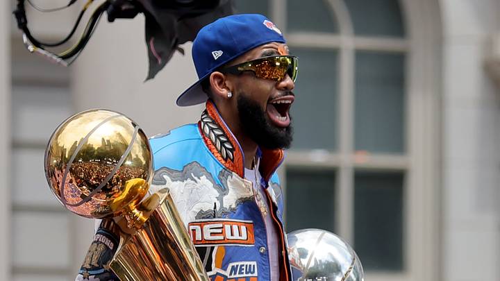 New York Knicks center Karl-Anthony Towns celebrates with the Larry O'Brien championship trophy and the eastern conference finals trophy during a ceremony at New York City Hall after the championship parade.