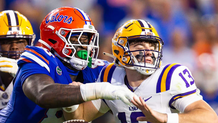 Florida Gators defensive lineman Caleb Banks (88) causes a fumble as he strips the ball from LSU Tigers quarterback Garrett Nussmeier (13) during the second half at Ben Hill Griffin Stadium in Gainesville, FL on Saturday, November 16, 2024. The Gators defeated the Tigers 27-16. [Doug Engle/Gainesville Sun]