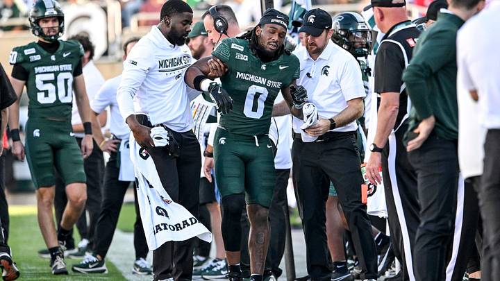 Michigan State’s Cam Edwards RB NiJhay Burt CB is helped off the sideline after suffering an injury against Nebraska during the first quarter on Saturday, Sept. 26, 2026, in East Lansing.