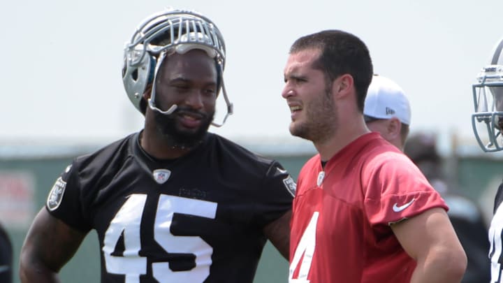 Jun 9, 2015; Oakland, CA, USA; Oakland Raiders quarterback Derek Carr (4) with fullbacks Marcel Jun 9, 2015; Oakland, CA, USA; Oakland Raiders quarterback Derek Carr (4) with fullbacks Marcel