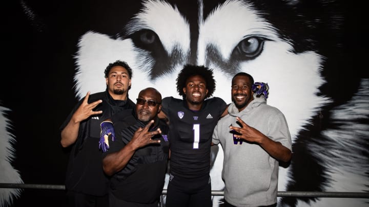 Wide receiver Deji Ajose takes a photo with his host coaches. 