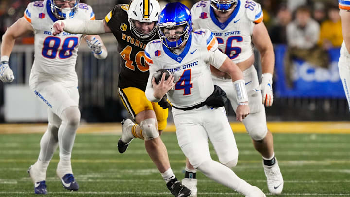 Nov 23, 2024; Laramie, Wyoming, USA; Boise State Broncos quarterback Maddux Madsen (4) runs against the Wyoming Cowboys during the third quarter at Jonah Field at War Memorial Stadium. Mandatory Credit: Troy Babbitt-Imagn Images


