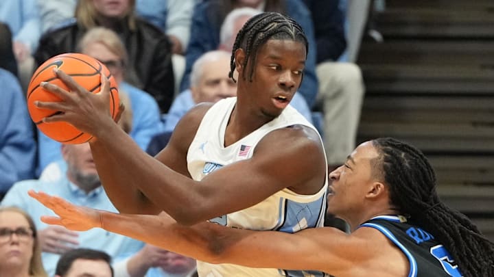 Feb 7, 2026; Chapel Hill, North Carolina, USA;  North Carolina Tar Heels forward Caleb Wilson (8) with the ball as Duke Blue Devils forward Maliq Brown (6) defends in the first half at Dean E. Smith Center. Mandatory Credit: Bob Donnan-Imagn Images